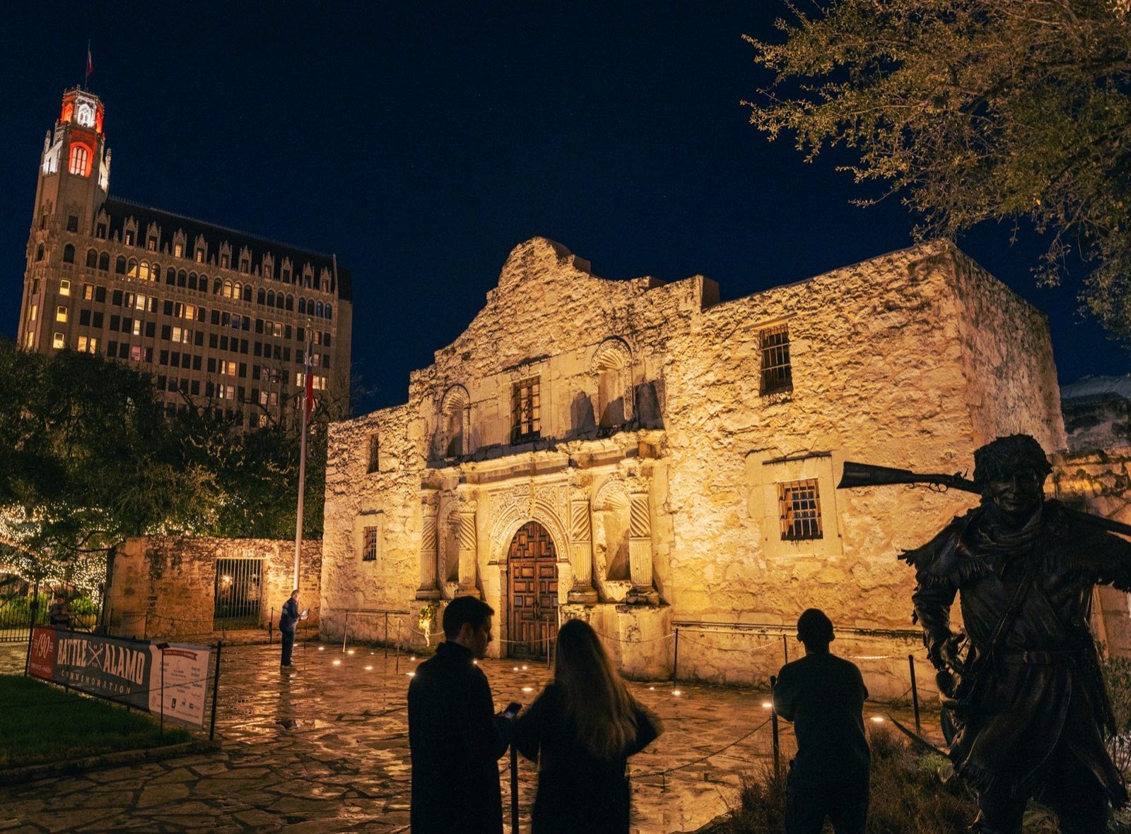 Alamo Plaza at night beneath the lit Emily Morgan tower