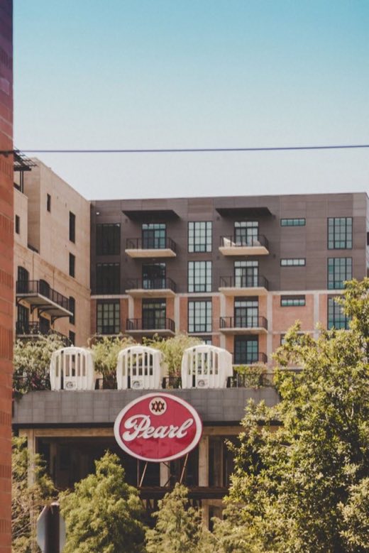 Apartment balconies rising behind the Pearl sign in San Antonio