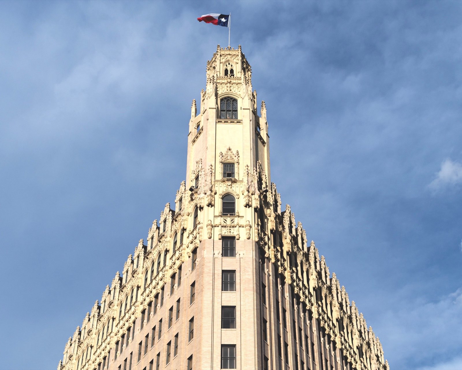 Gothic-revival tower flying the Texas flag over downtown San Antonio