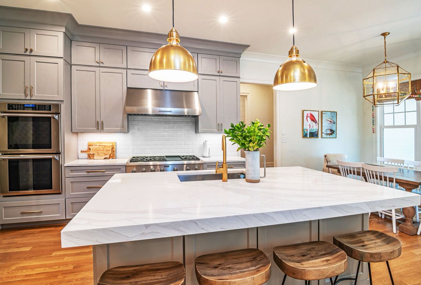 Kitchen island under brass pendant lights