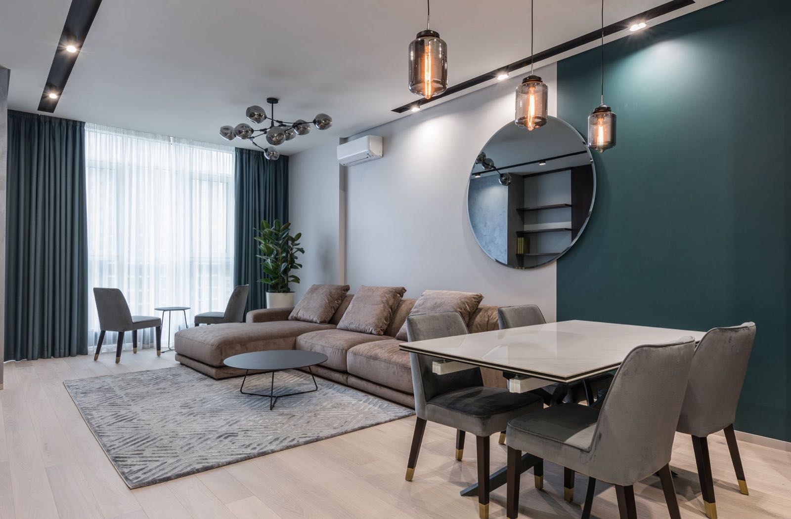 Living room with deep sofas and a marble dining table