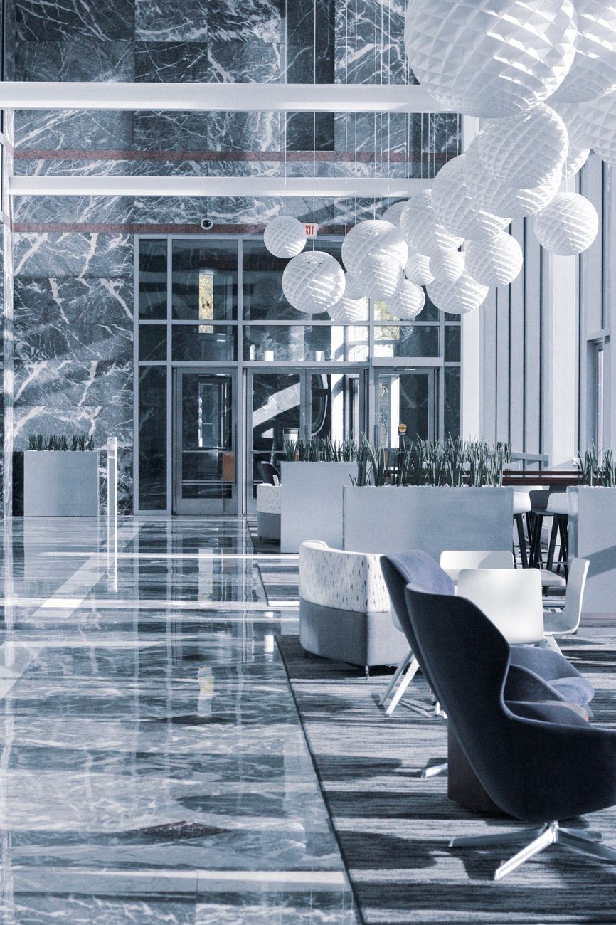 Marble-clad lobby with lounge seating and paper lanterns