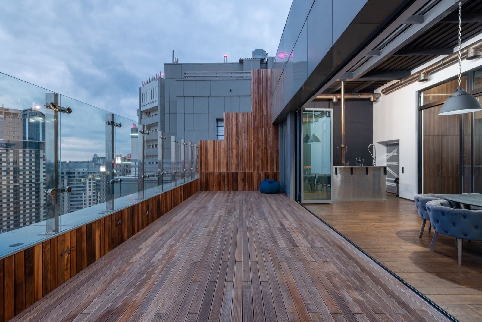 Wraparound wooden penthouse terrace at dusk