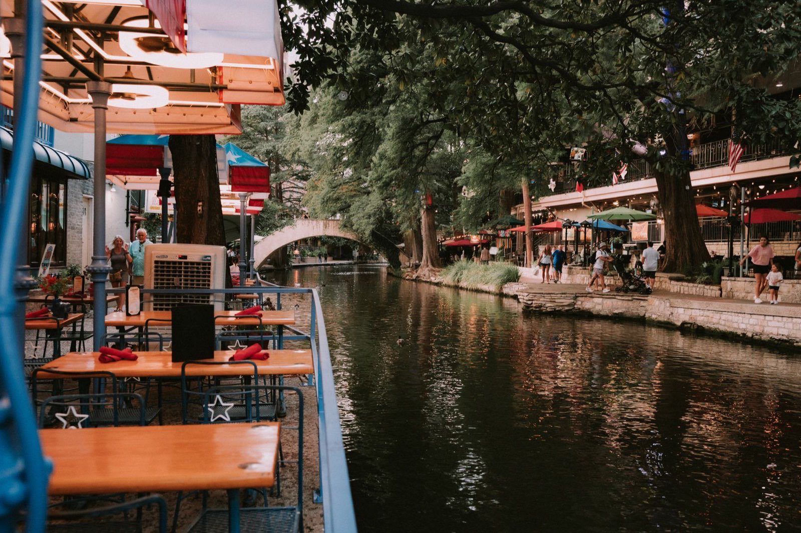Riverside dining terraces along the San Antonio River Walk at dusk