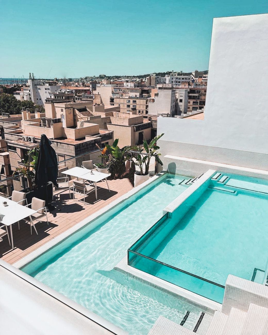 Rooftop pool and terrace above city rooftops